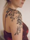 Flowers vines tattoo on girl shoulder